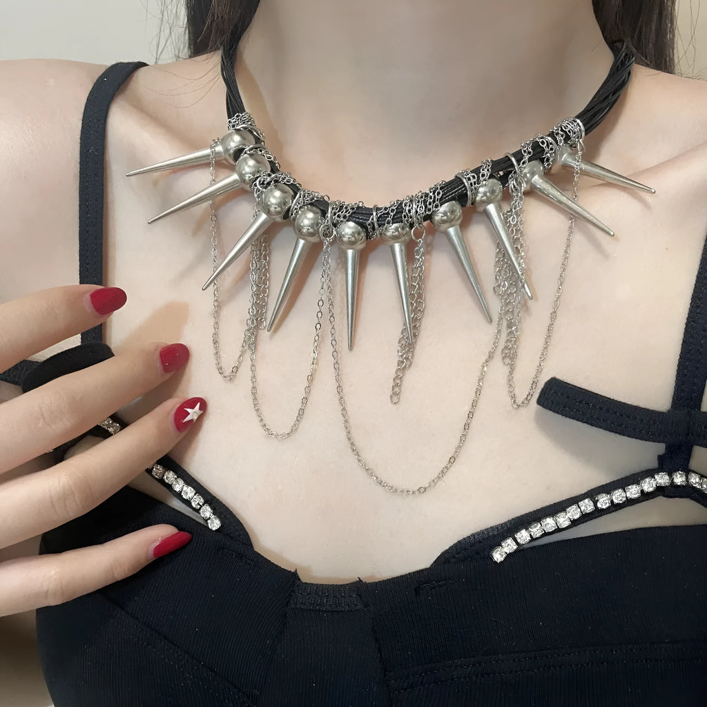 Women's leather necklace with round beads, a winding tassel, and silver point rivets on a casual outfit.