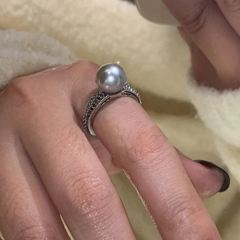 Geometric open copper ring for women with a black pearl on an adjustable band.
