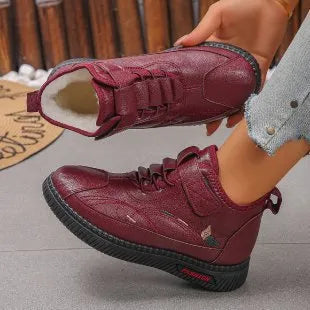 Women's black velvet shoes with non-slip rubber sole and hollow-out pattern.