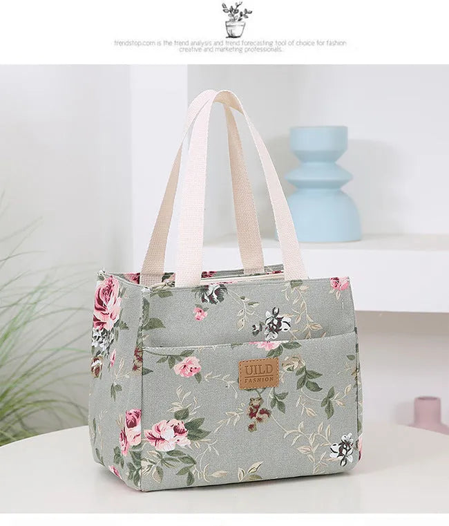 Women's printed canvas bag with aluminium frame showing floral pattern design and horizontal square shape