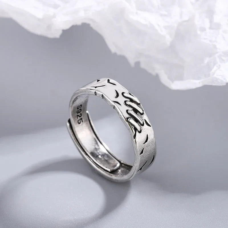 Black geometric adjustable ring with round and oval elements on copper base