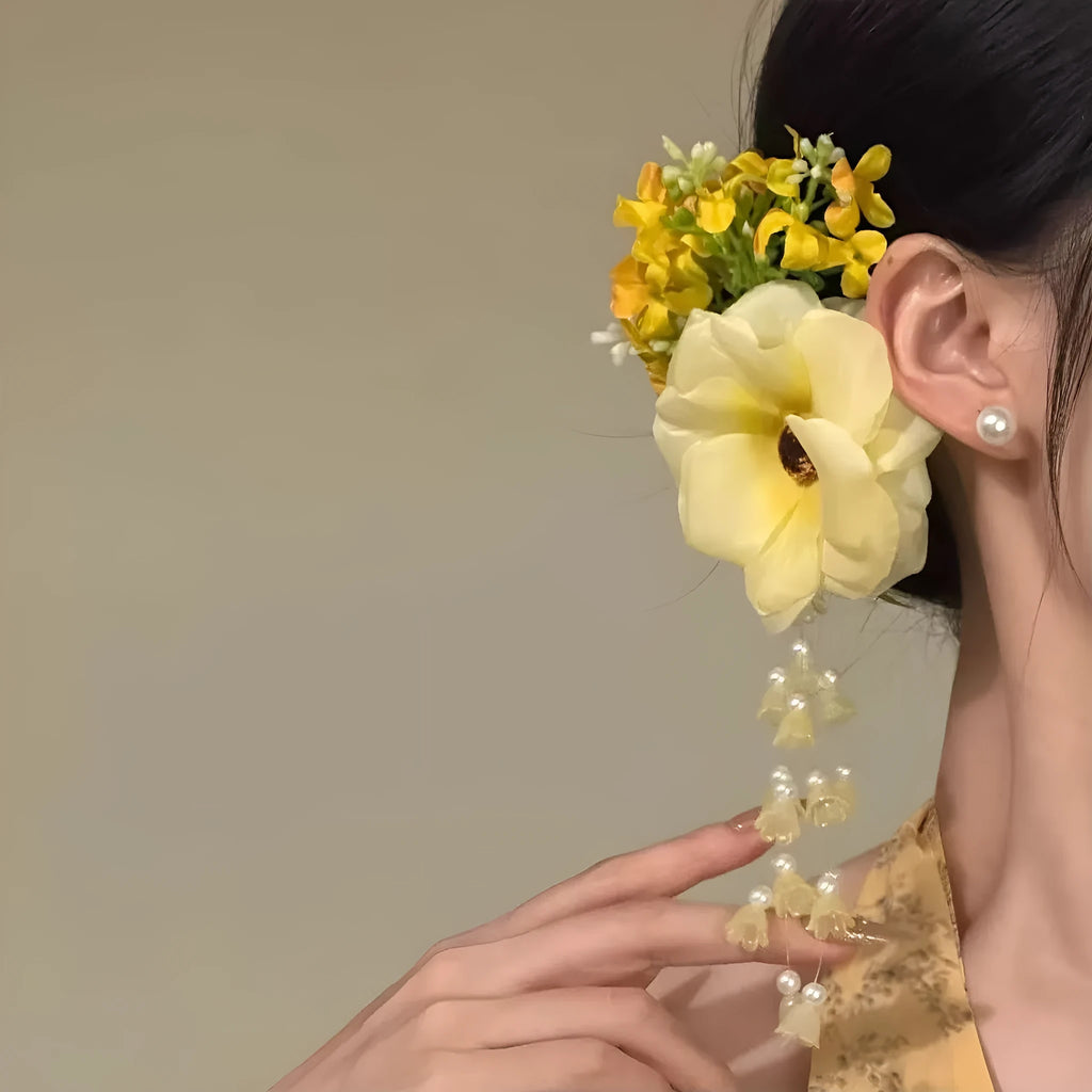 Yellow tassel side clip hair accessory with flower and pearl decorative elements