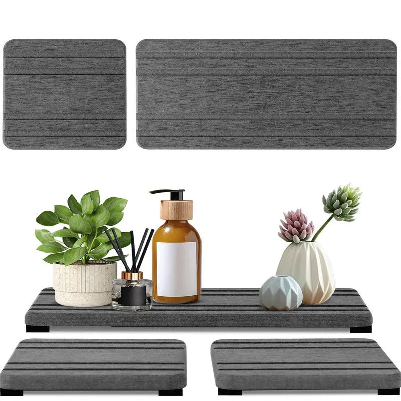 Set of three square diatomite bathroom countertop drying mats in solid grey colour.
