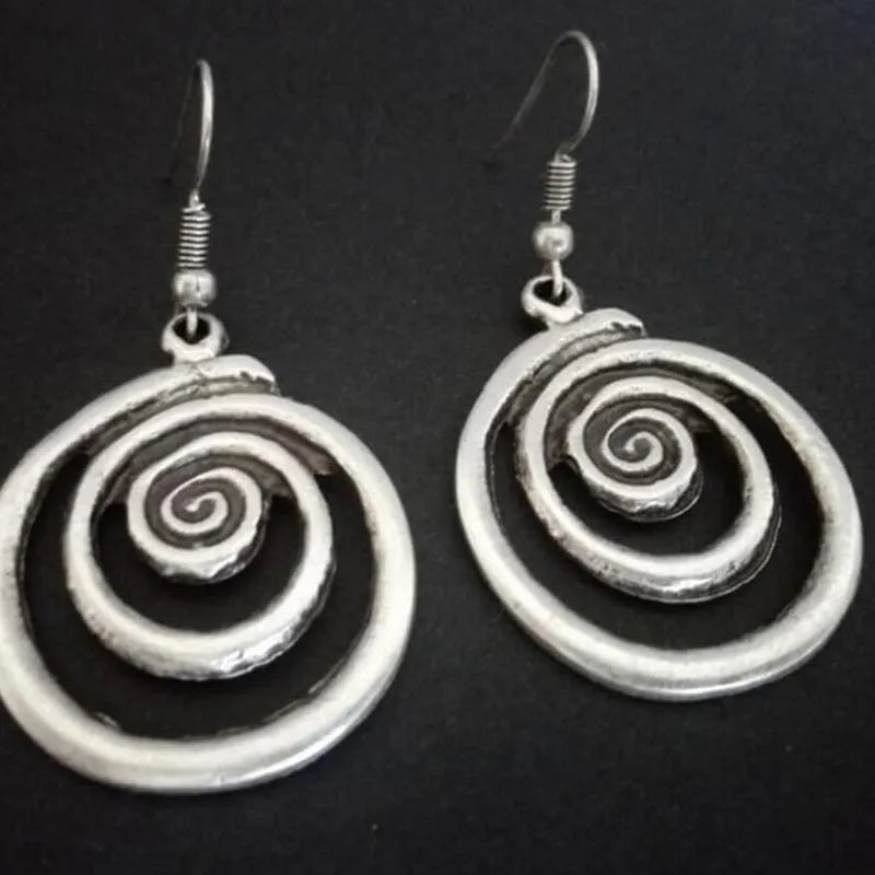 Silver geometric spiral earrings with distressed finish, measuring 2.6cm wide by 5cm long