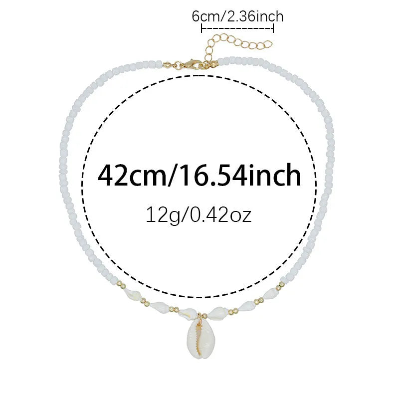 White conch shell bead necklace with mother of pearl pendant on a silver-toned electroplated chain.