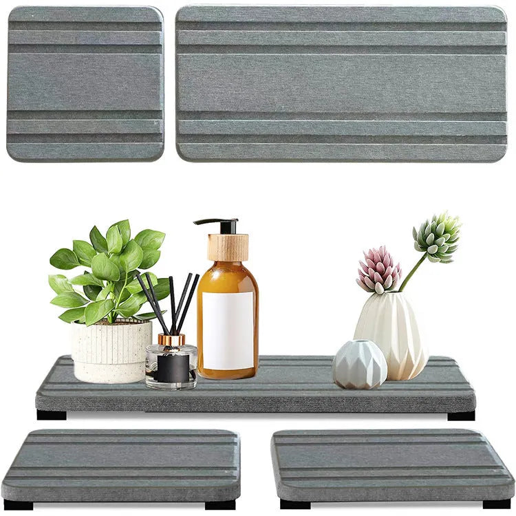 Set of three square diatomite bathroom countertop drying mats in solid grey colour.