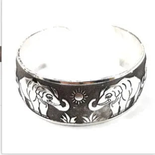 Open carved Miao silver alloy bracelet with elephant and turtle motifs on a Roman-shaped band.