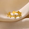 Geometric titanium steel women's ring with gold diamond finish on grey background