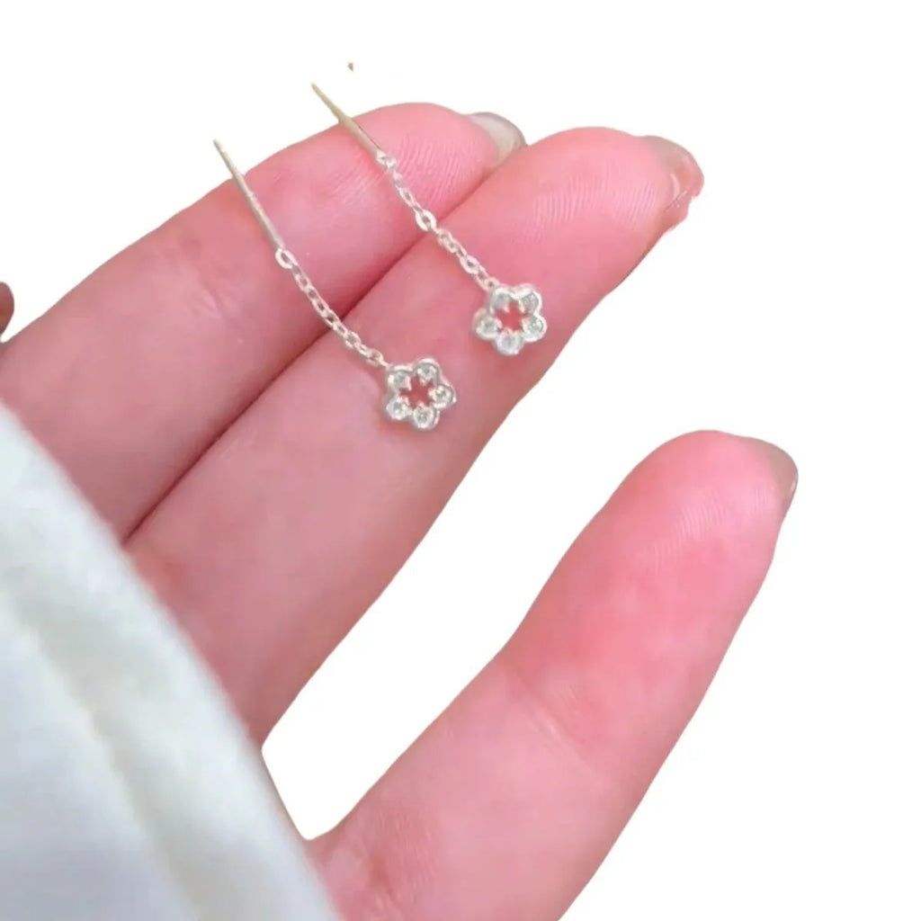 Pair of silver hollow flower stud earrings with detailed petals, alloy material with natural style