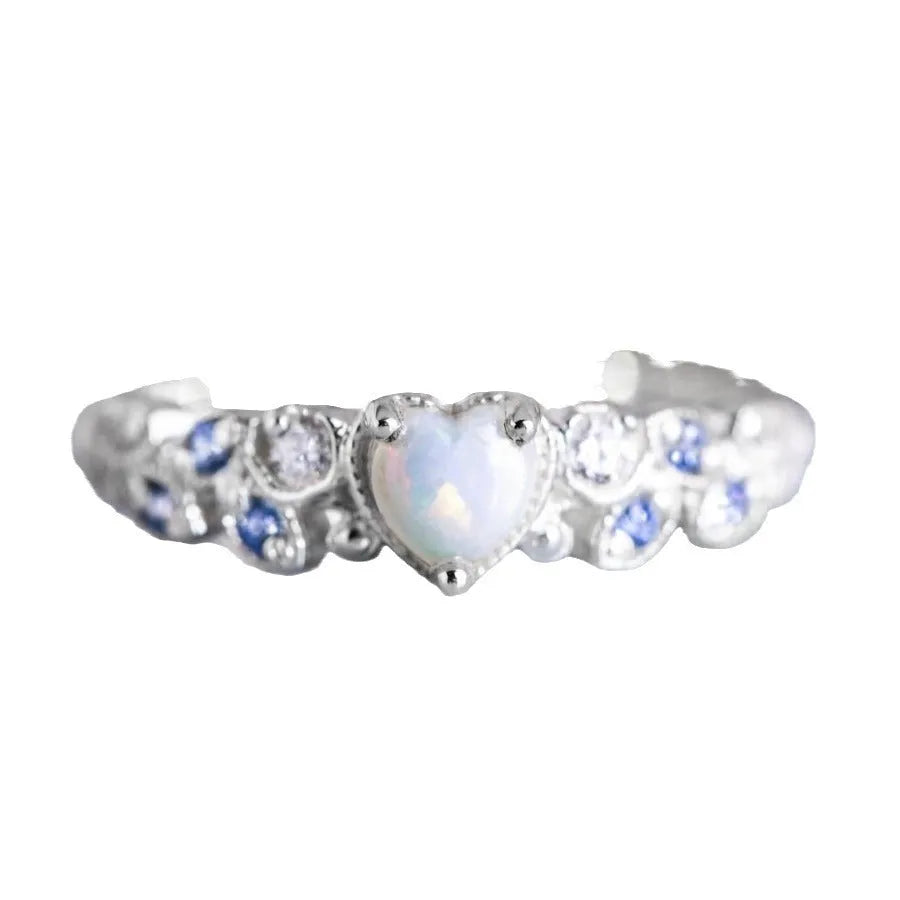 White alloy women's heart ring with flower opal ocean design on model finger