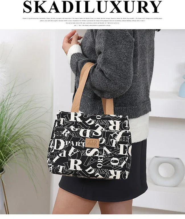 Women's printed canvas bag with aluminium frame showing floral pattern design and horizontal square shape