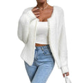 White women's V-neck cardigan sweater with bead knit detail on a hanger.