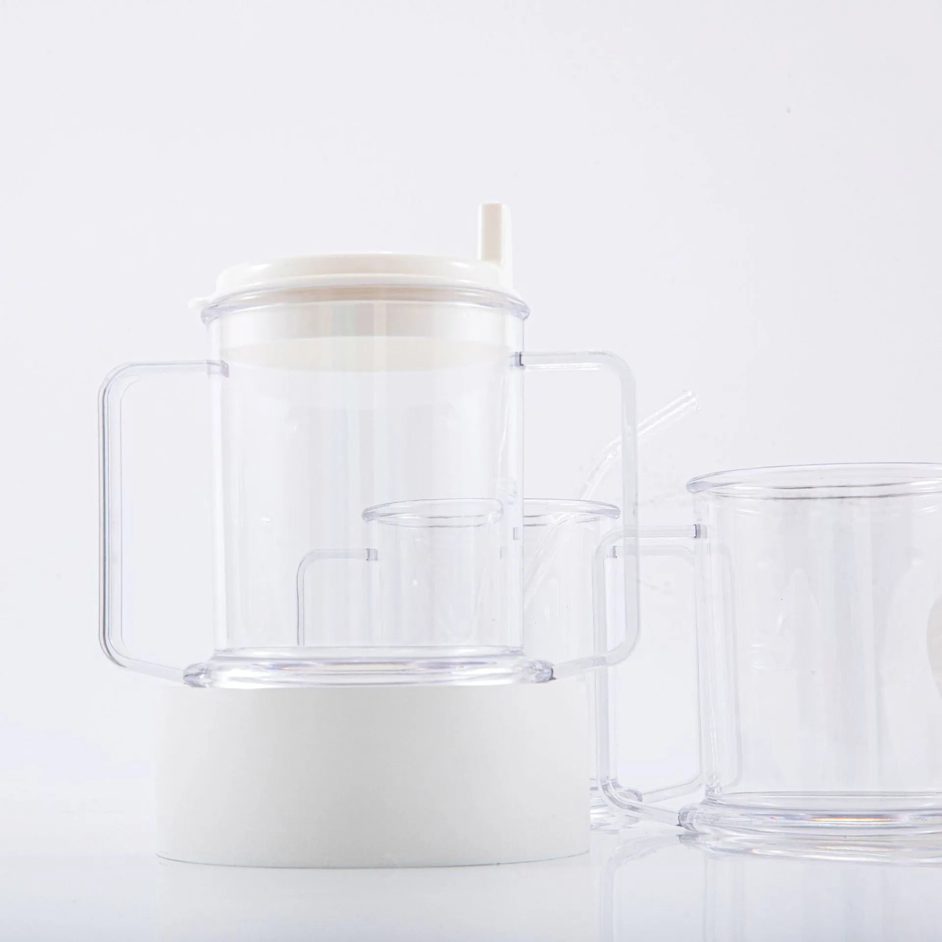 Transparent lightweight plastic drinking cup with spill-proof design on a plain background