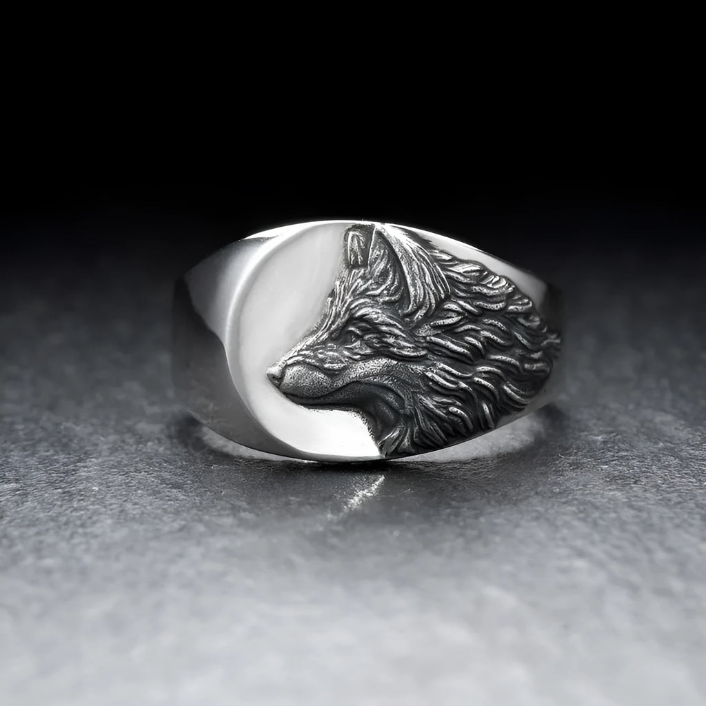 Men's silver geometric wolf head alloy ring on a grey background.