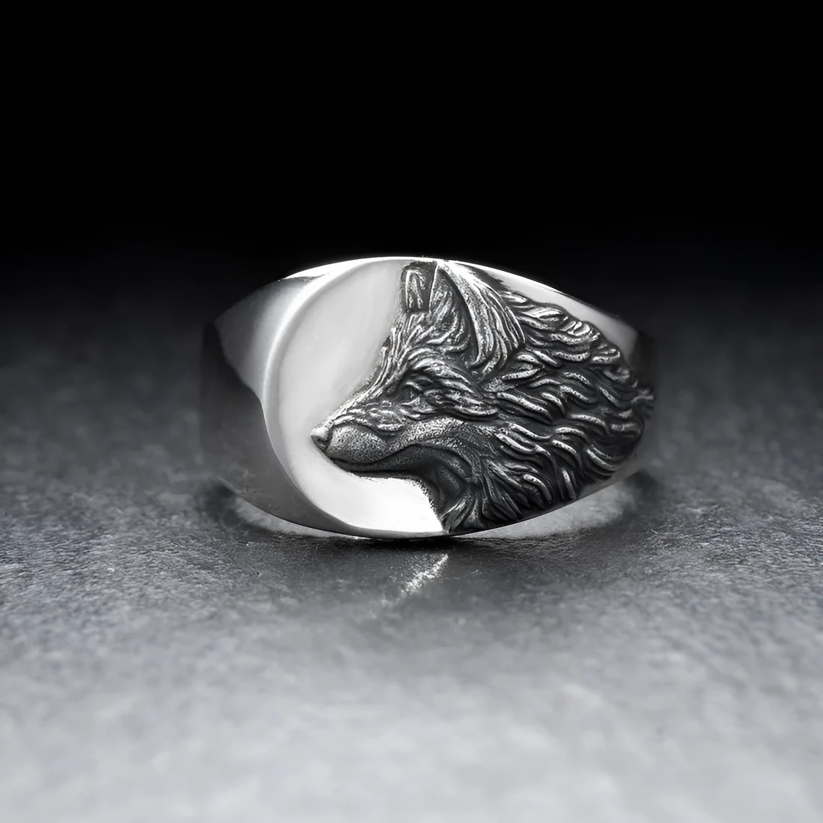 Men's silver geometric wolf head alloy ring on a grey background.