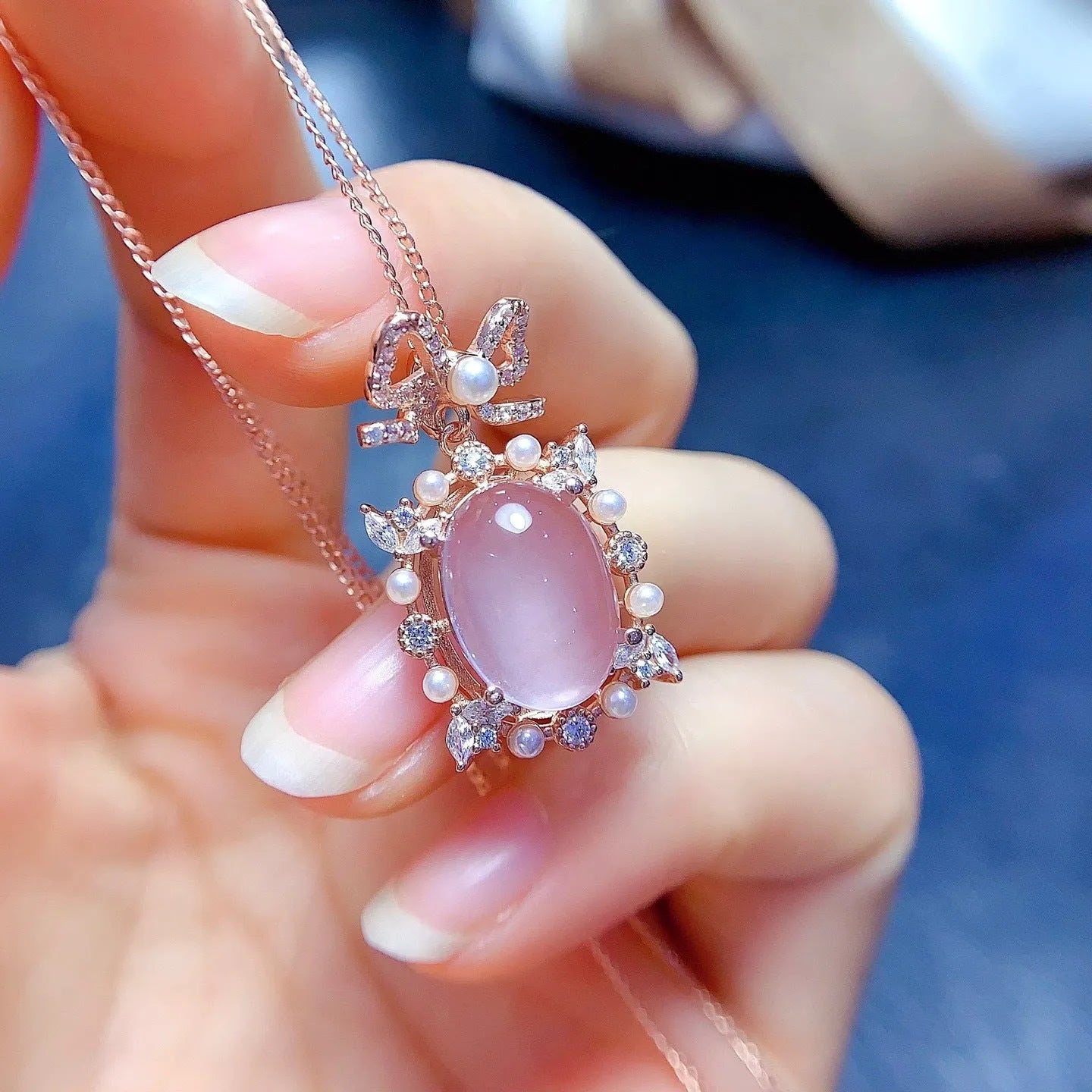 Geometric rose quartz crystal pendant on a silver chain with rose gold plating