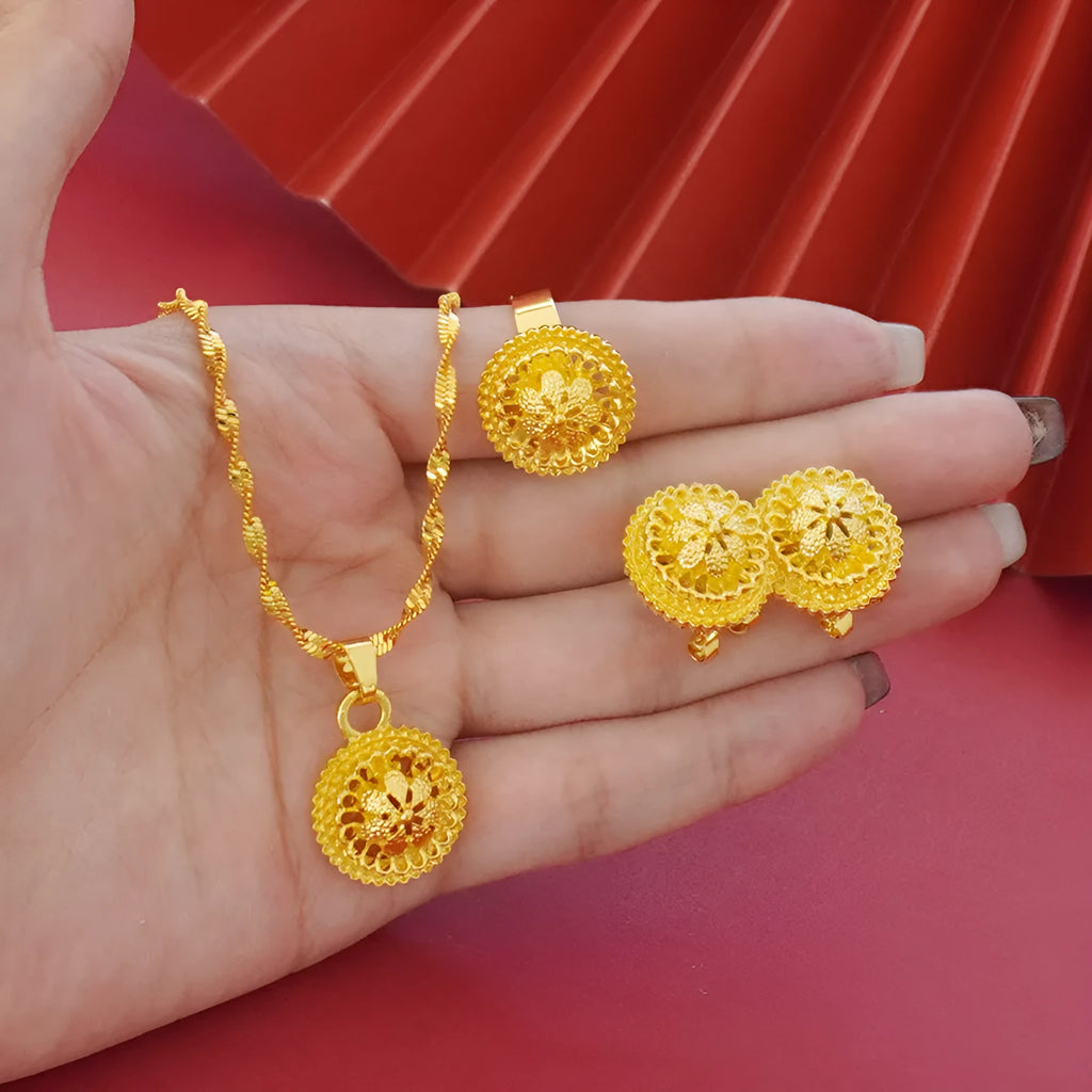 Women's three-piece jewellery set showing gold electroplated necklace with floral pendant, matching earrings, and ring with Middle Eastern design