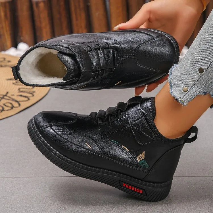 Women's black velvet shoes with non-slip rubber sole and hollow-out pattern.