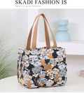 Women's printed canvas bag with aluminium frame showing floral pattern design and horizontal square shape