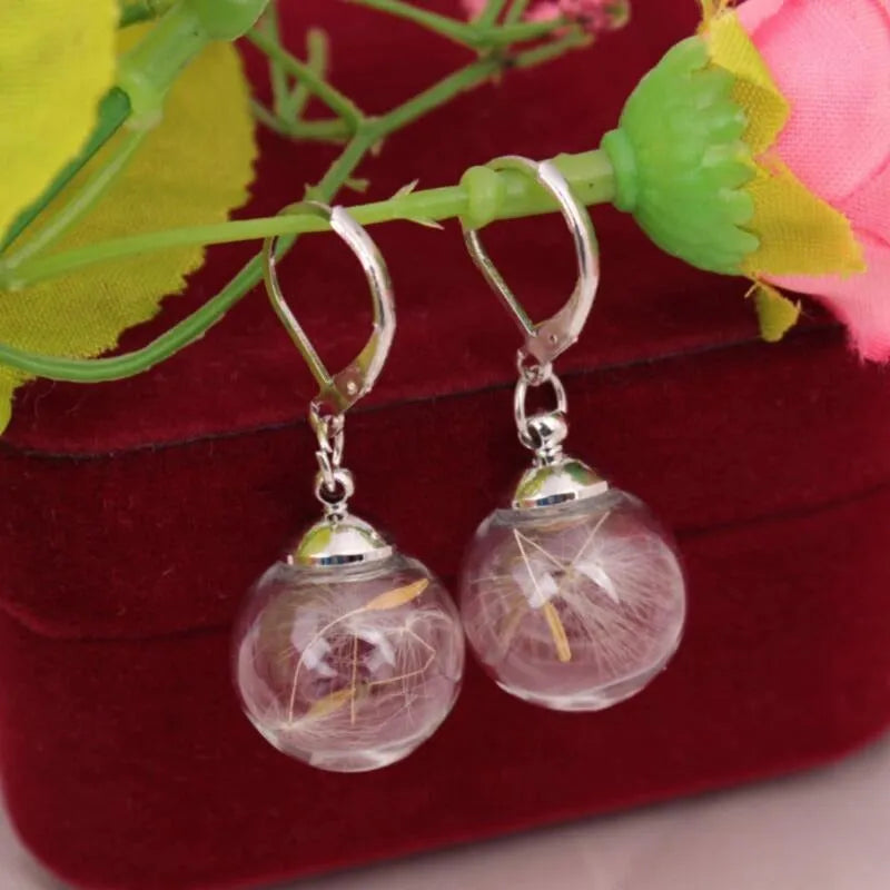 Transparent glass earrings with crystal dandelion seed design on French hooks