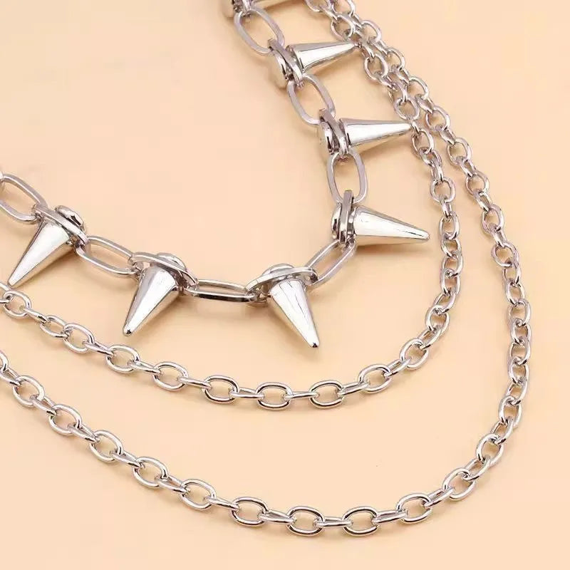 Silver metal double-layer rivet chain trousers accessory with zip fastening on a dark background.