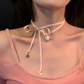 Close-up of a women's alloy love pendant necklace with electroplated finish on a clavicle chain.