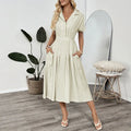 Light green twill shirtdress with lapel collar, waist-tight skirt, and commuter pocket design