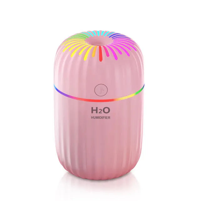 Mini animal-shaped USB aromatherapy humidifier in green, pink, or white colour on a desk.