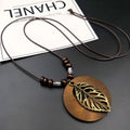 Wooden leaf necklace with adjustable chain and vintage textile accents in ethnic style