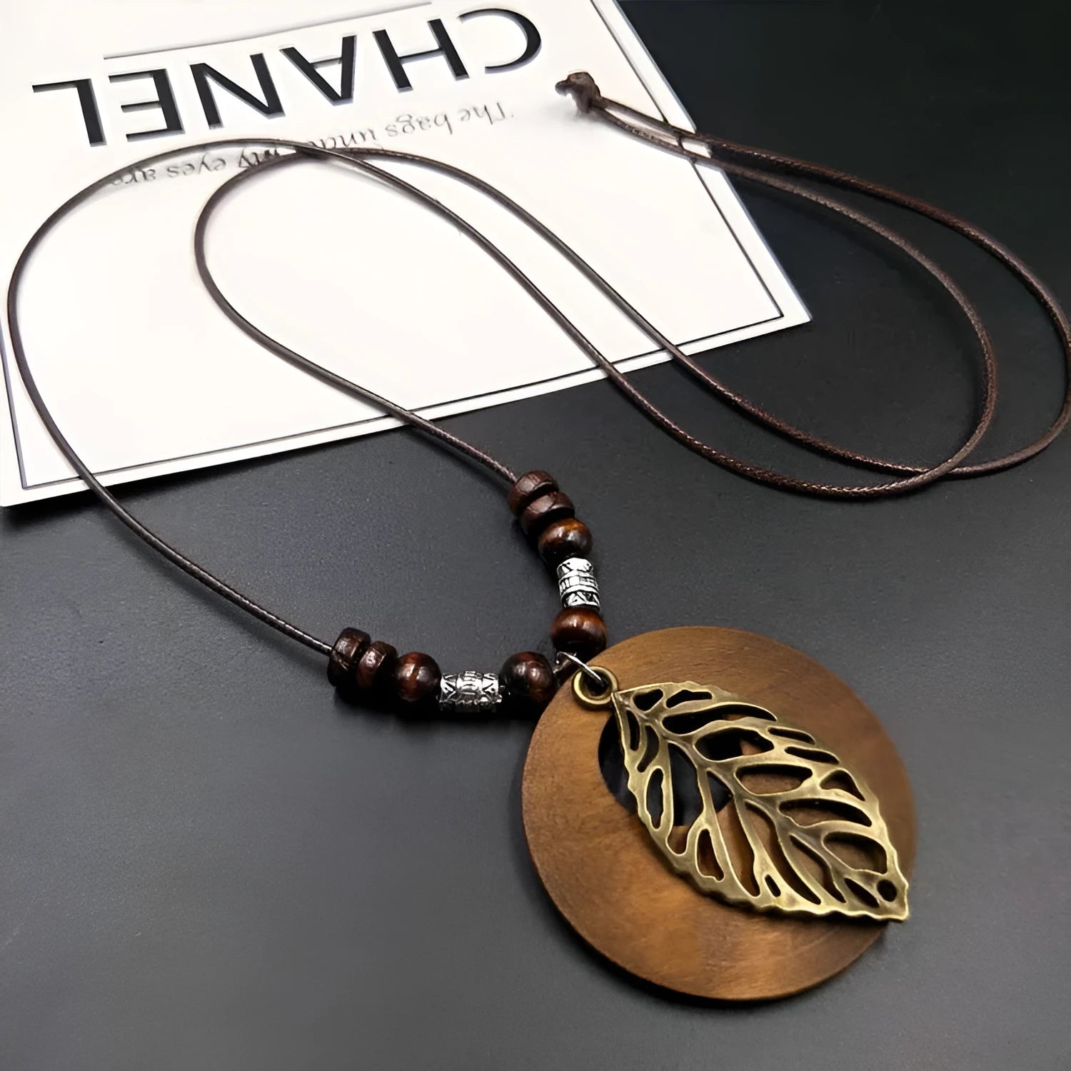 Wooden leaf necklace with adjustable chain and vintage textile accents in ethnic style