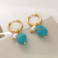 A pair of short and a pair of dangle geometric turquoise copper earrings.