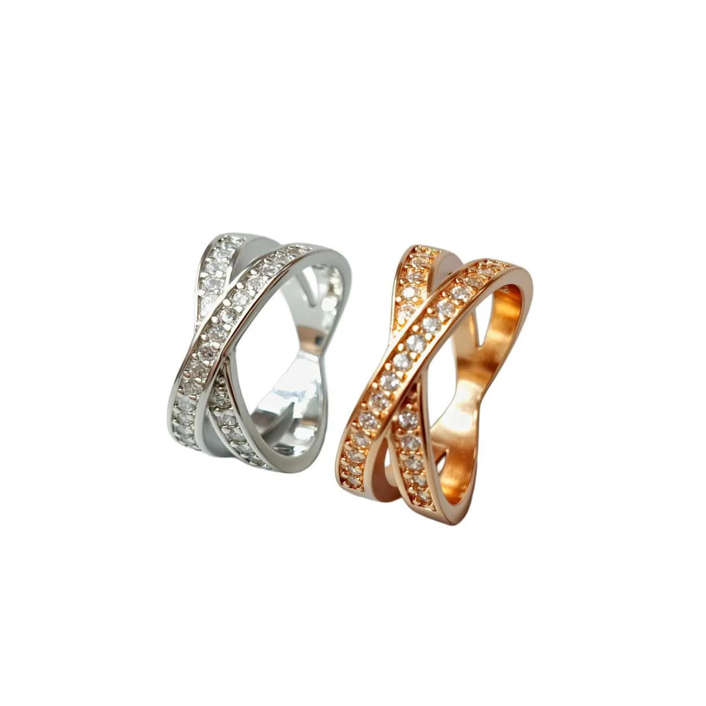 Geometric heart-shaped cross ring with micro-inlaid zircon on a copper base with silver or rose gold electroplated finish.
