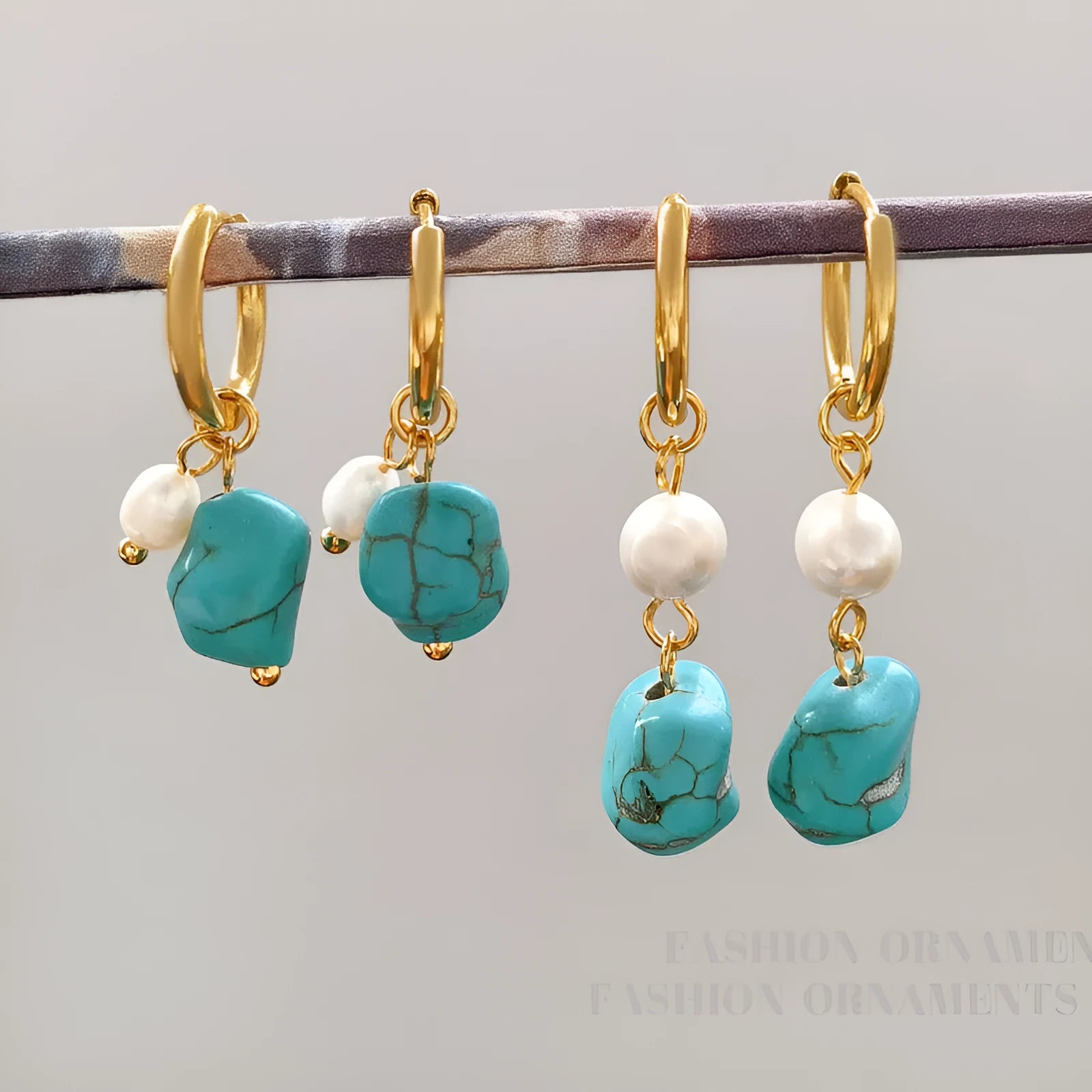 A pair of short and a pair of dangle geometric turquoise copper earrings.