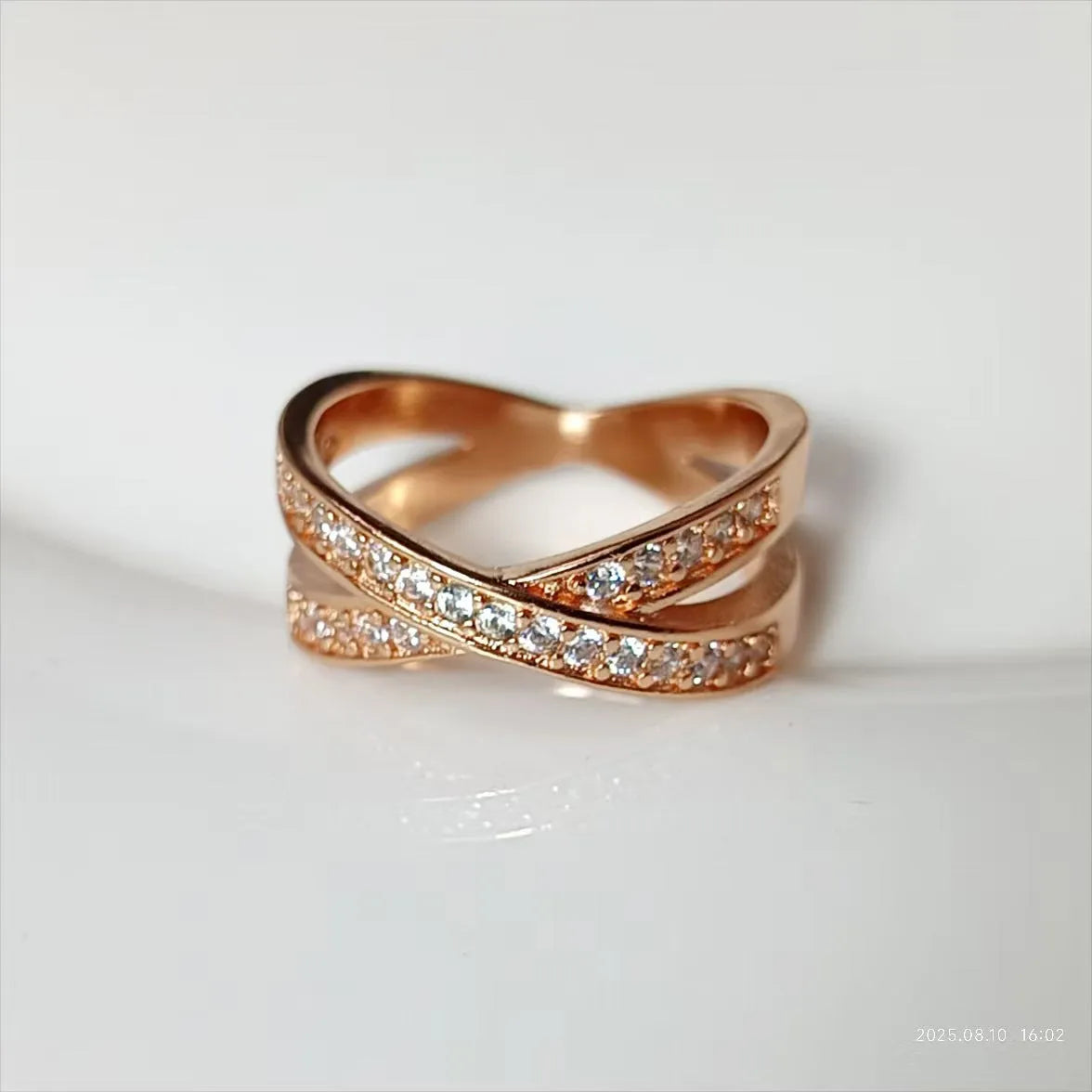Geometric heart-shaped cross ring with micro-inlaid zircon on a copper base with silver or rose gold electroplated finish.