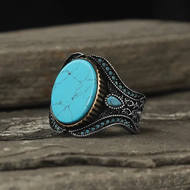 Men's antique silver alloy ring with round turquoise stone on finger