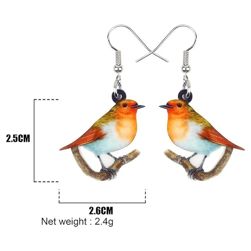 Blue Titmouse pendant earrings with geometric and snake designs on acrylic