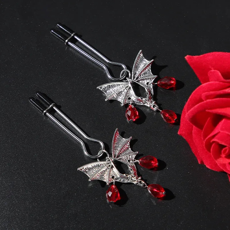 Silver alloy bat nipple clamp with ruby design showing adjustable pressure mechanism