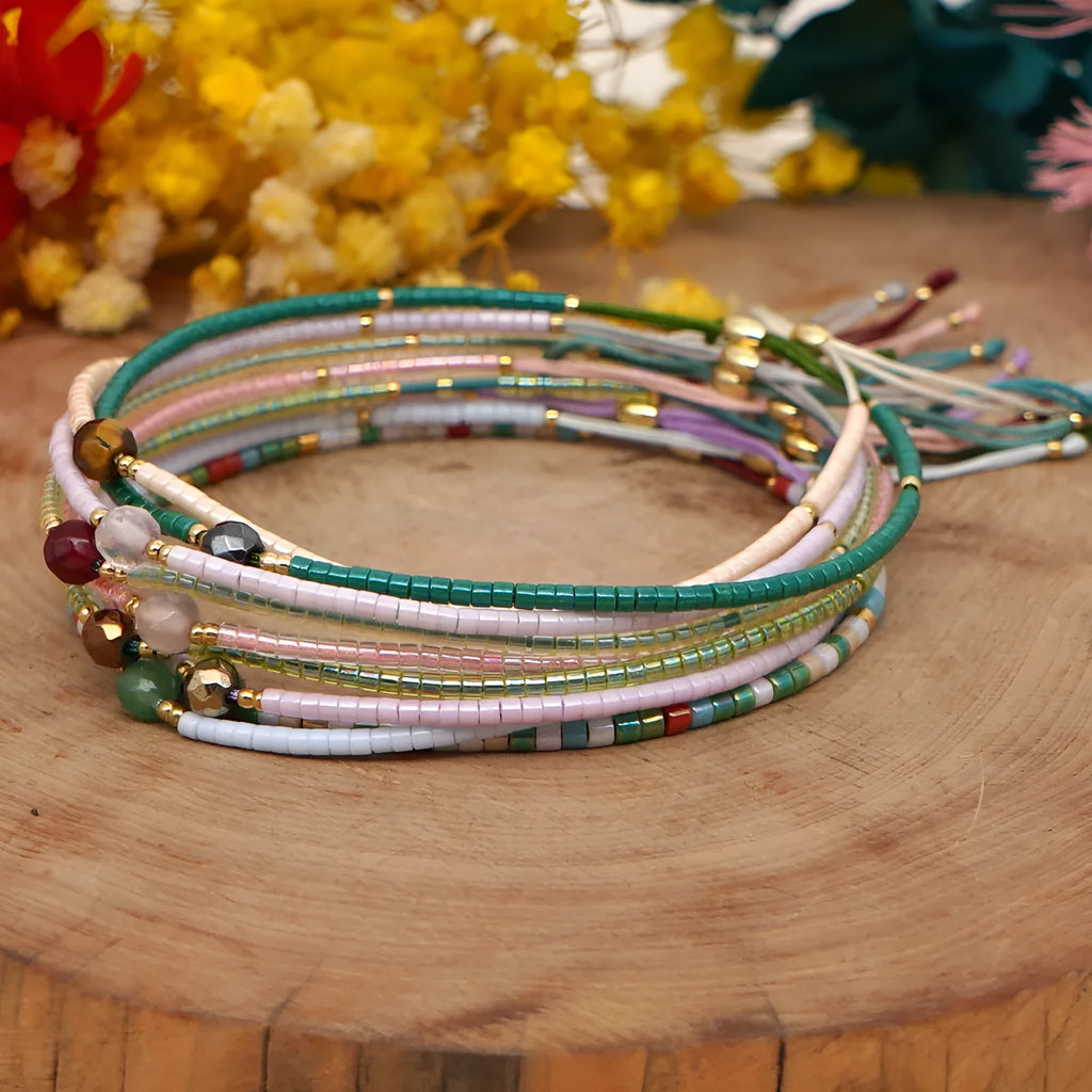 Handmade bohemian-style bracelet with semi-precious stone and colourful glass beads on a wrist.