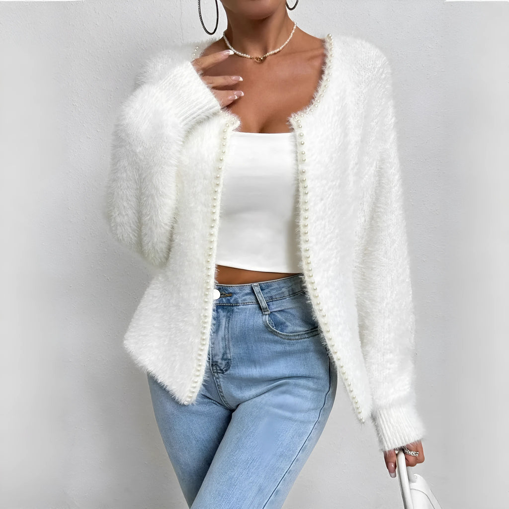 White women's V-neck cardigan sweater with bead knit detail on a hanger.