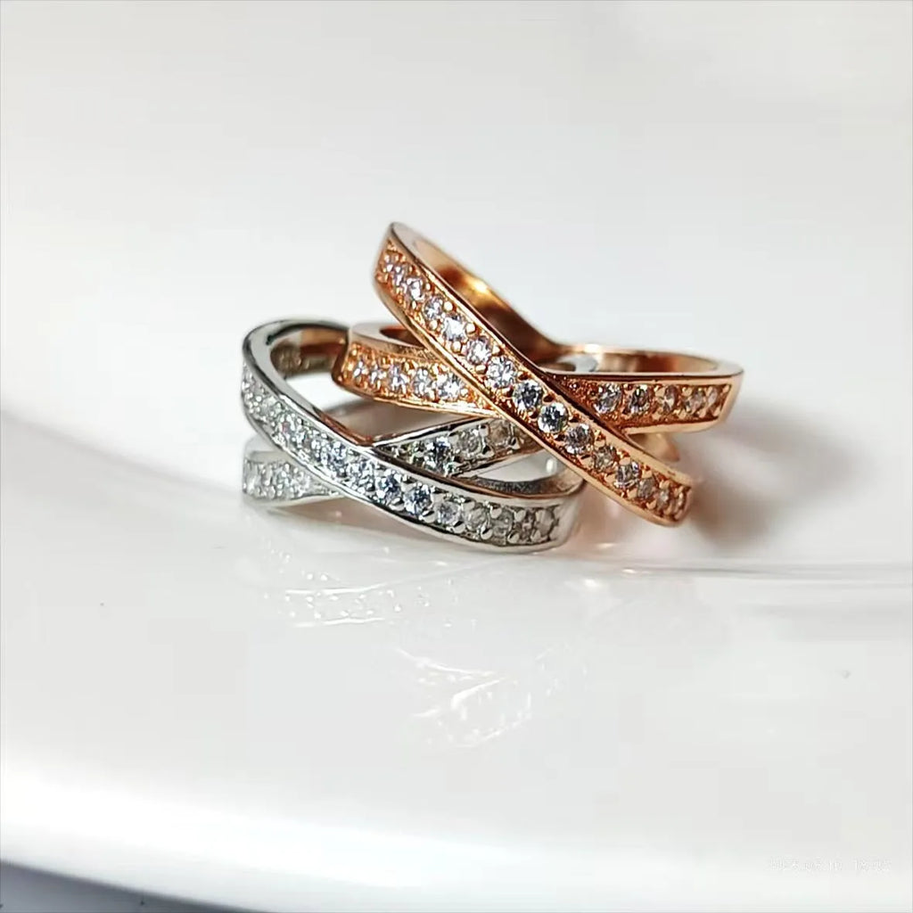 Geometric heart-shaped cross ring with micro-inlaid zircon on a copper base with silver or rose gold electroplated finish.