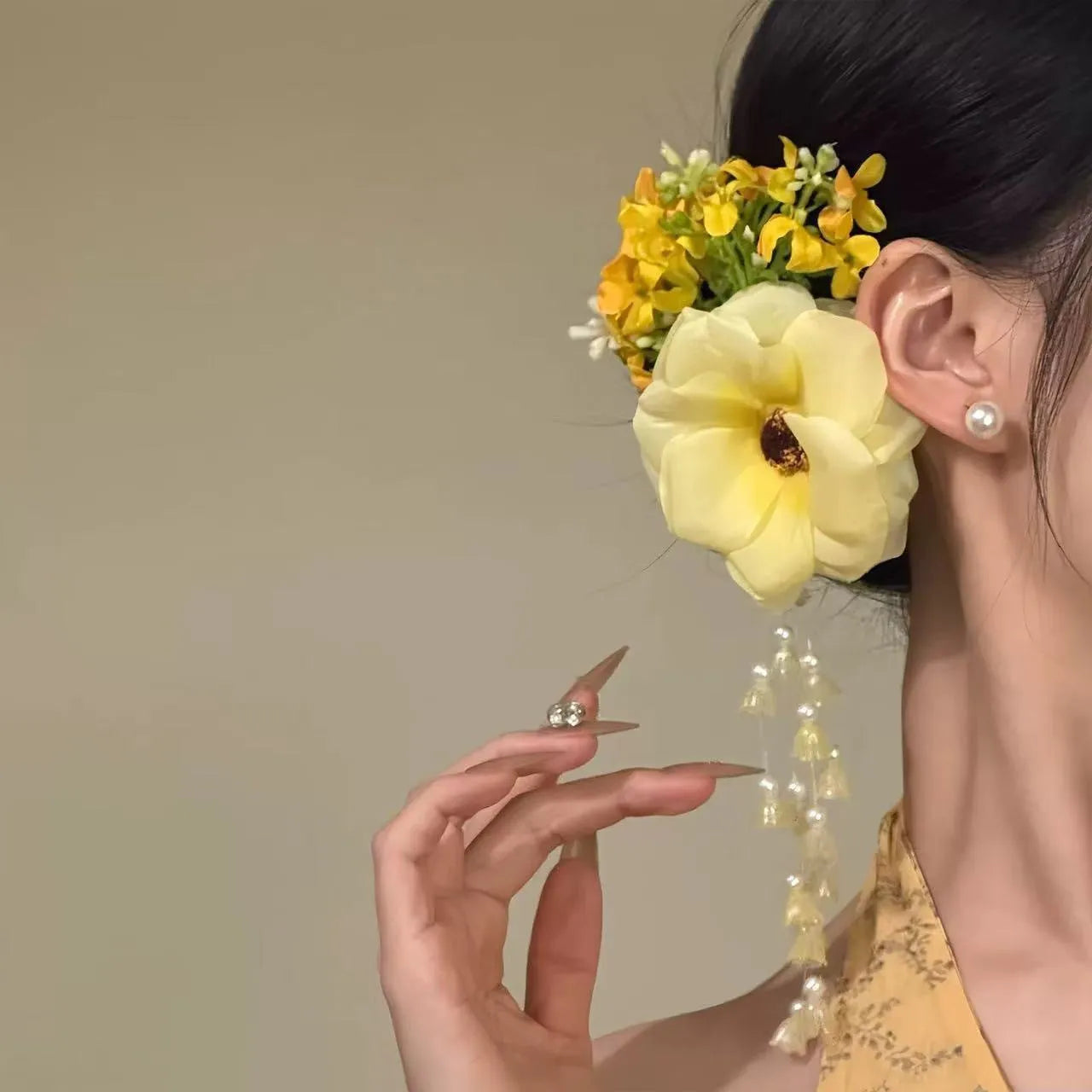 Yellow tassel side clip hair accessory with flower and pearl decorative elements