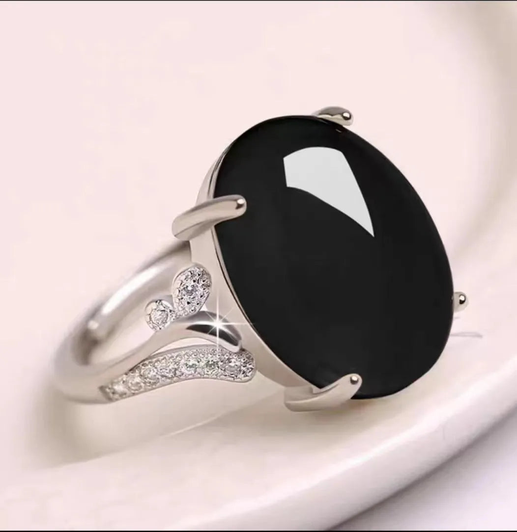 Adjustable geometric ethnic-style alloy ring with a natural sapphire, shown in multiple colour options.