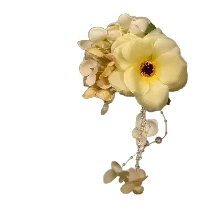 Yellow tassel side clip hair accessory with flower and pearl decorative elements