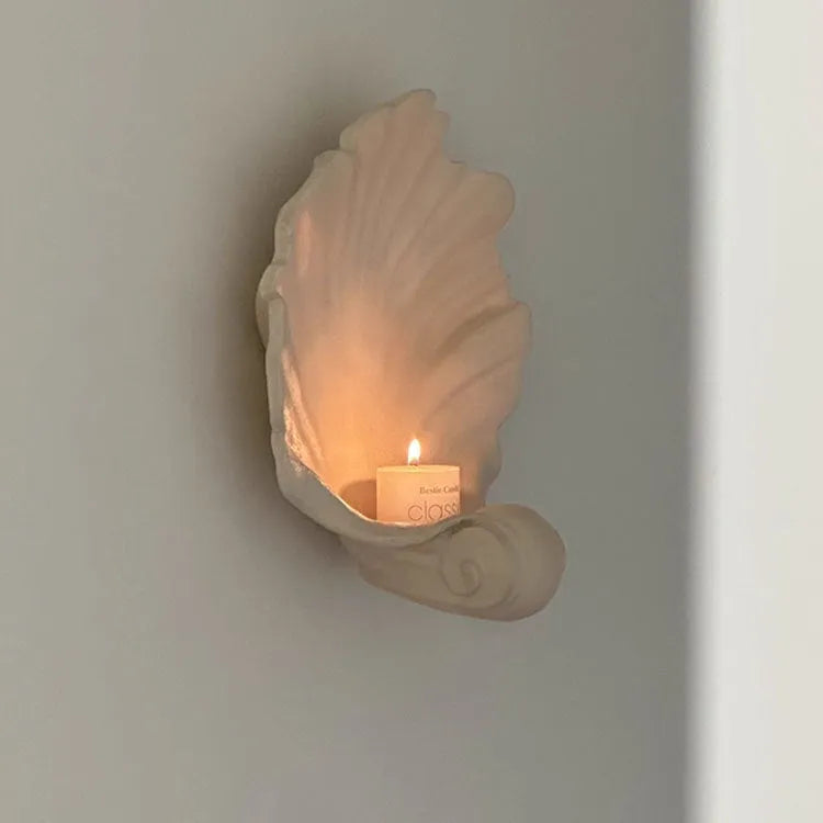 White resin simulation shell fruit plate ornament on a table.