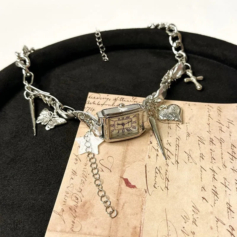 Dark electroplated multi-layer cross necklace with twin clavicle chains on display