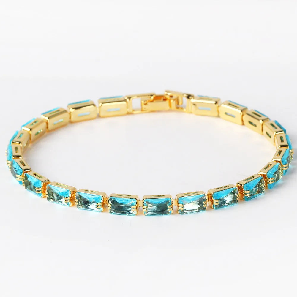 Adjustable electroplated zircon bracelet in gold finish with coloured zircon accents