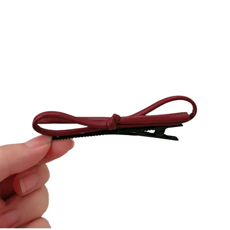 Wine red leather bow barrettes hair clips showing bow design and leather material