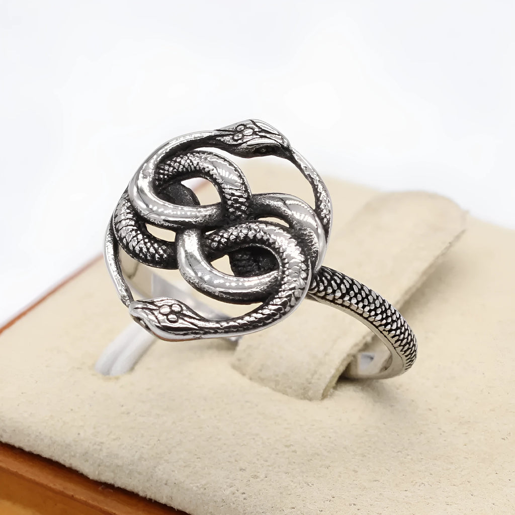 Close-up of a steel-coloured titanium steel double snake ring on a hand, showing retro design.