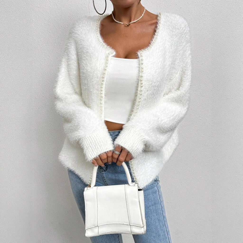 White women's V-neck cardigan sweater with bead knit detail on a hanger.