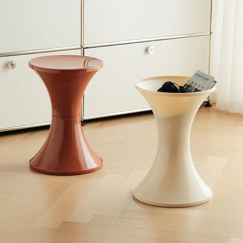 Green hourglass-shaped plastic stool for changing shoes, suitable for children and adults.